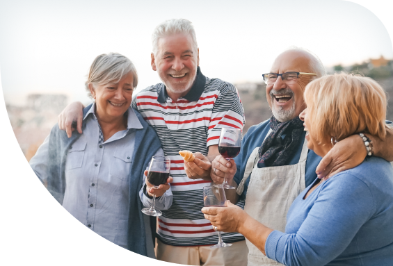 4 older friends raising a glass of wine