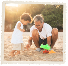 Grandpa playing in the sand with Grandchild