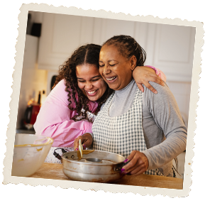 Mother and her daughter in the kitchen cooking together