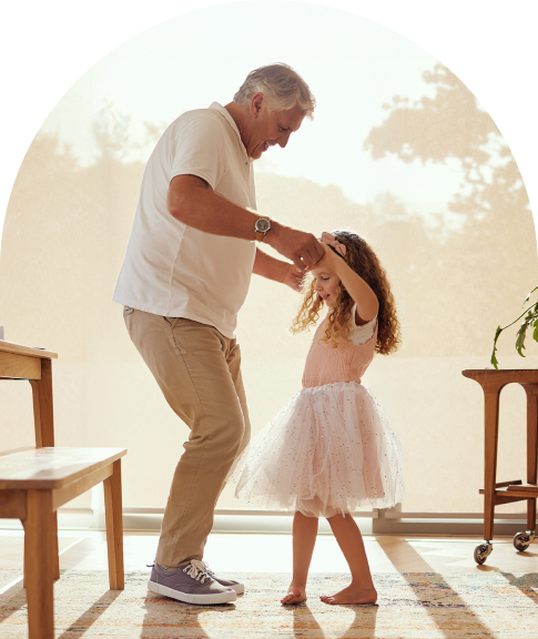 grandfather dancing with his young granddaughter