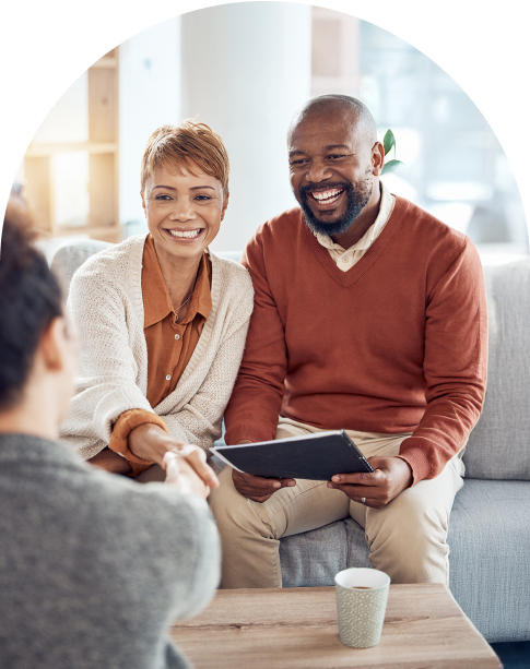 couple sitting on couch looking at materials